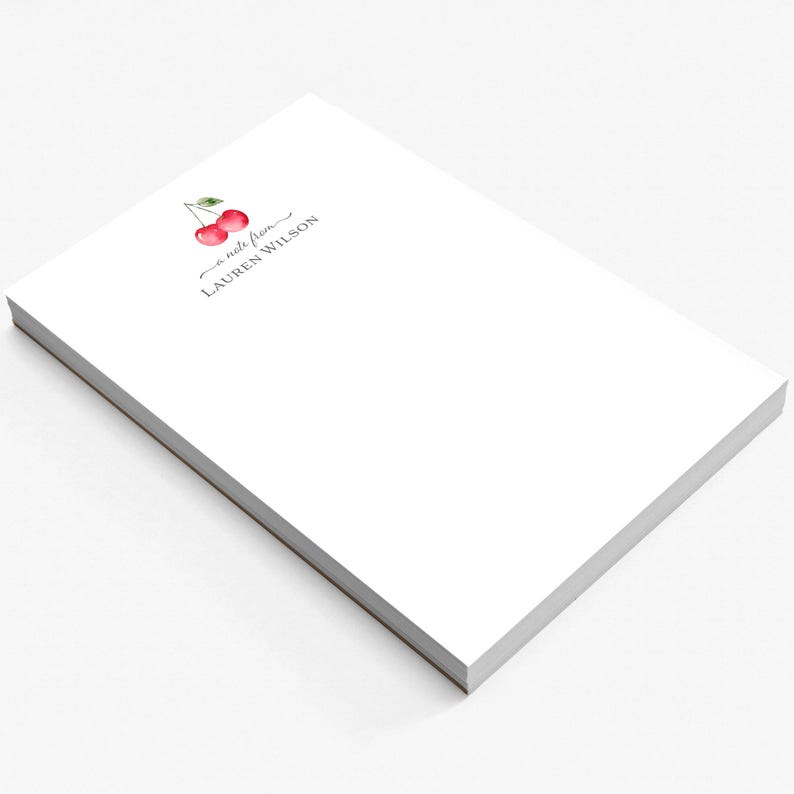 May include: A white notepad with a cherry illustration and the text "a note from LAUREN WILSON".