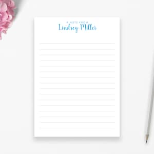 May include: A white notepad with lined paper and the text "A note from Lindsey Miller" at the top in blue.