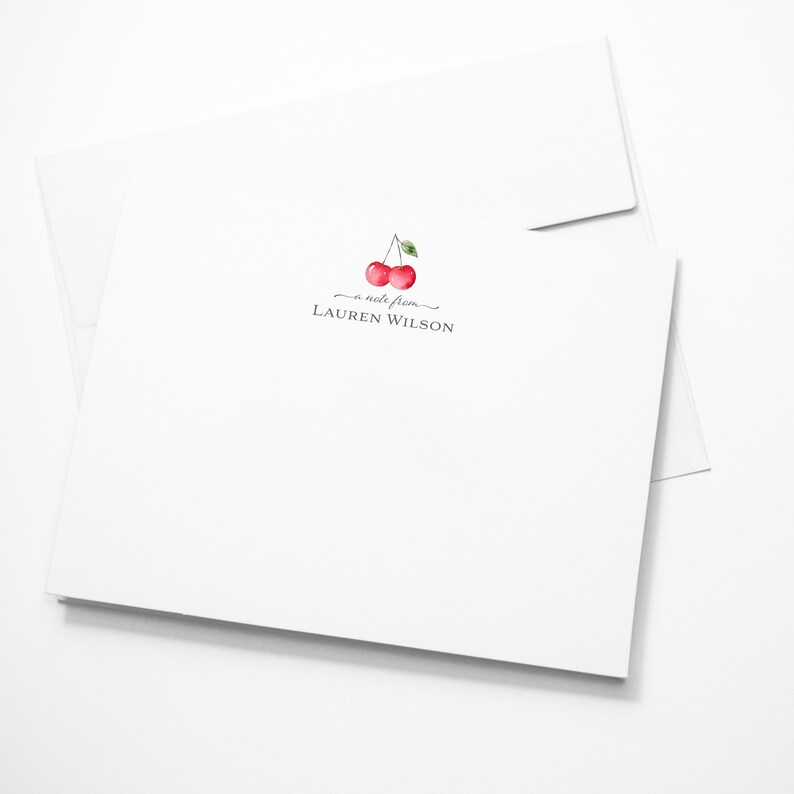May include: A white card with a cherry illustration and the text "a note from LAUREN WILSON".