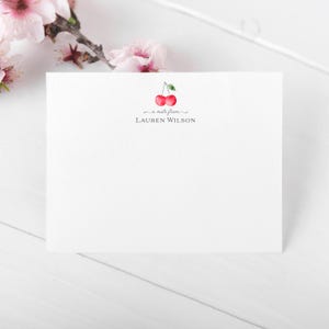 May include: A white card with a red cherry illustration and the text "a note from LAUREN WILSON".