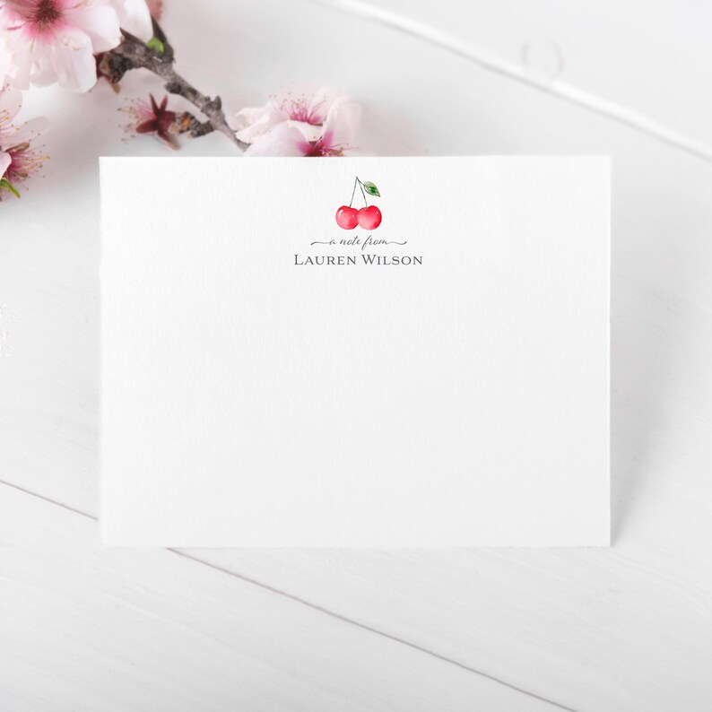 May include: A white card with a red cherry illustration and the text "a note from LAUREN WILSON".