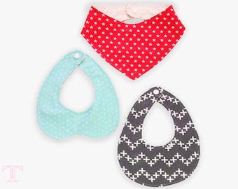 May include: Three baby bibs with different patterns. One bib is red with white stars, one is light blue with white dots, and one is black with white crosses.