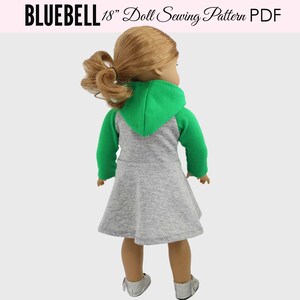May include: A gray and green hooded dress for an 18 inch doll. The dress has a gray body and green sleeves and hood.