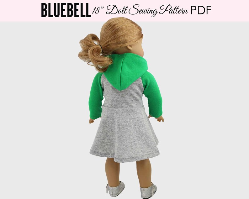 May include: A gray and green hooded dress for an 18 inch doll. The dress has a gray body and green sleeves and hood.