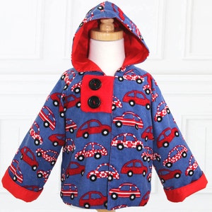 May include: A blue hooded jacket with red trim and a red car print. The jacket has two black buttons.
