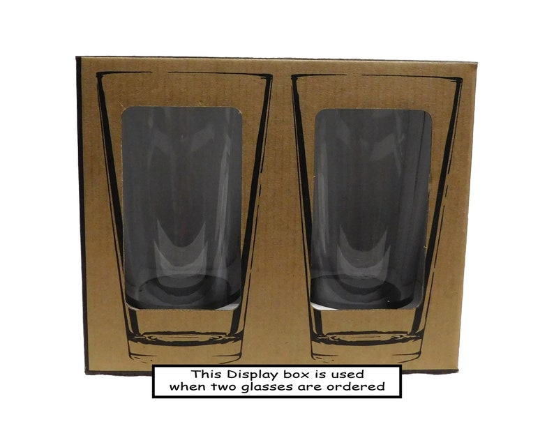 May include: A brown cardboard box containing two clear glass tumblers. The box has the text "This Display box is used when two glasses are ordered" printed on the bottom.
