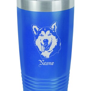 May include: A blue stainless steel tumbler with a white Alaskan Malamute dog silhouette and the word "Name" engraved on it.