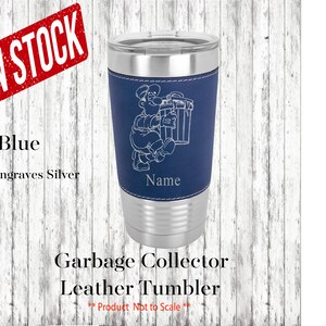 May include: Blue leather tumbler with a silver engraved design of a cartoon character holding a trash can. The text "Garbage Collector" and "Name" are also engraved on the tumbler.