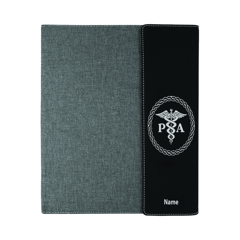 May include: A gray and black binder with a medical symbol and the letters "PA" in a circle. The binder has a stitched edge and the words "Name" are printed on the front.