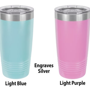 May include: Two stainless steel tumblers with lids. The tumbler on the left is light blue and the tumbler on the right is light purple. Both tumblers have a silver band around the top and engrave silver.