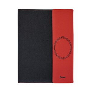 May include: A black and red leather notebook with a decorative circle design and the word "Name" on the front.