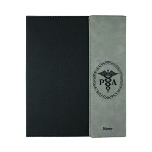May include: A gray and black leatherette folder with a medical symbol and the letters "PA" in a circle. The folder has a stitched edge and the text "Name" is printed on the right side.