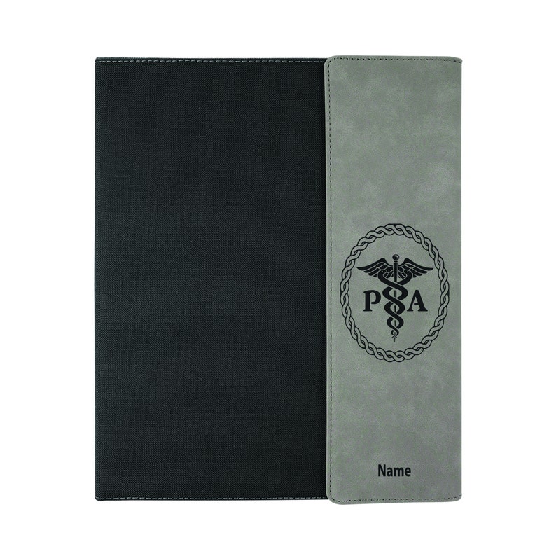 May include: A gray and black leatherette folder with a medical symbol and the letters "PA" in a circle. The folder has a stitched edge and the text "Name" is printed on the right side.