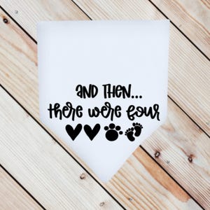 May include: White fabric with black text that reads "And then... there were four" with two black hearts and a black paw print and two black footprints.