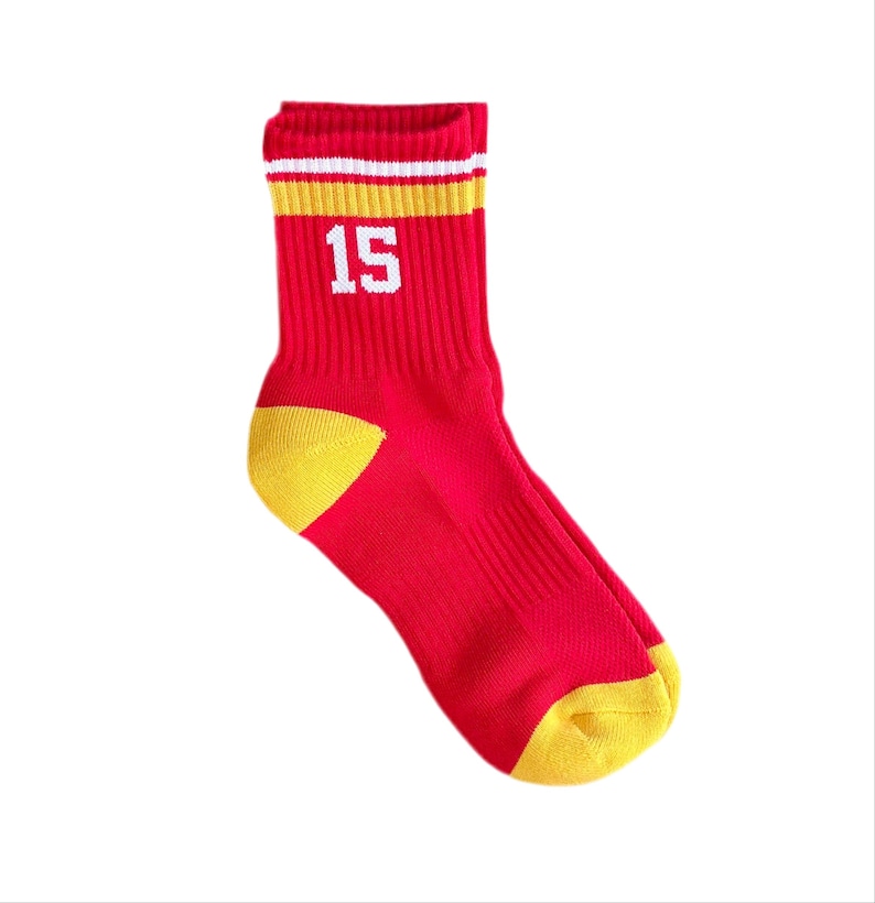 May include: Red and yellow athletic socks with a white stripe and the number 15 printed on the front.