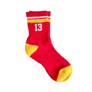 May include: Red and yellow striped athletic socks with the number 13 printed in white.
