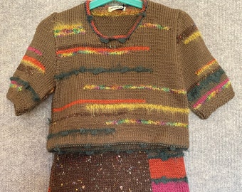 Little girl's hand-knitted jumper (sweater) and skirt.