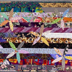 May include: A colorful quilt with a striped pattern and five flower-shaped designs. The quilt is made of various fabrics with different patterns and colors, including purple, blue, green, yellow, and orange.