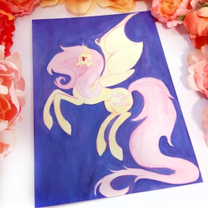 May include: A colorful illustration of a winged pony with a flowing pink mane and tail, set against a deep blue background. The pony has yellow wings and a yellow body with pink accents. The artwork is surrounded by orange and pink flowers.