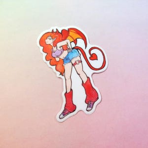 May include: A die-cut sticker featuring a cartoon character with long orange hair, pointed ears, and red wings. The character wears a purple crop top, blue denim shorts, and red leg warmers over sneakers. A long red tail with a heart-shaped tip is visible.