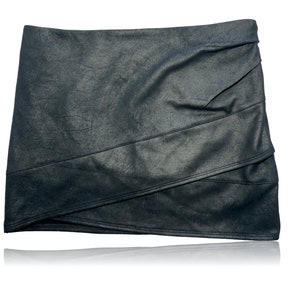 May include: A black faux leather mini skirt with a layered design and a slightly asymmetrical hem.