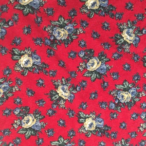 May include: Red fabric with a floral pattern featuring small blue and yellow flowers. The fabric has the word "BONGO" printed in white letters on a red background.