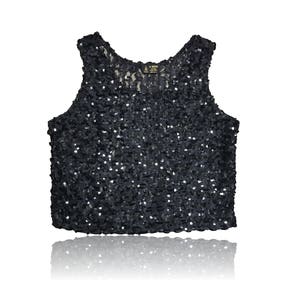 May include: A black sequined sleeveless top with a scoop neck.