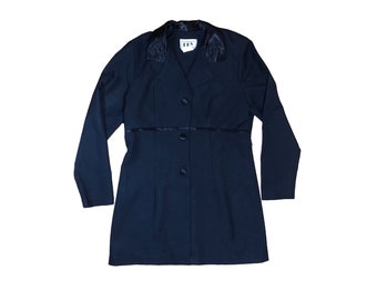 May include: A navy blue blazer with a satin collar and trim. The blazer has a button closure and long sleeves.