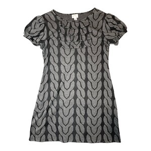 May include: A gray and black short-sleeved dress with a cable knit pattern and a ruffled neckline.