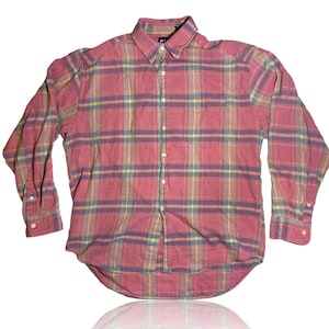 May include: A long-sleeved plaid shirt in shades of pink, green, and yellow. The shirt has a button-down collar and a single chest pocket.