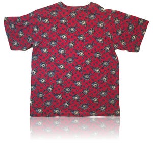 May include: A red short-sleeved t-shirt with a floral pattern. The flowers are blue and white.