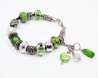 Green/white stitch marker keeper bracelet with Euro-style beads on a black leather cord