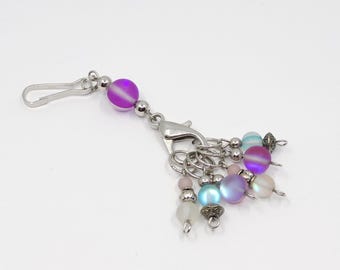 Opalescent beaded stitch marker holder featuring purple, blue and white opalescent glass bead stitch markers