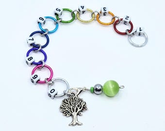 Jumbo, numbered, rainbow row counter, with silver coloured Tree charm and green cat -eyebead progress keeper.