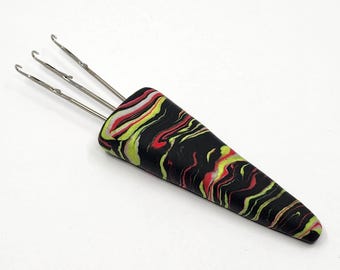 1 (M) swirl pattern Cord-i-Flix, i-cord making tool, in black/neon yellow/pink polymer clay with 3 medium hooks, for yarn weight DK to Aran.