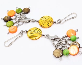 Yellow with black stripe shell bead bag charm featuring 6 shell bead stitch markers