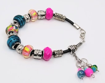 Iridescent, pink/teal stitch marker keeper bracelet with Euro-style beads on a black leather cord