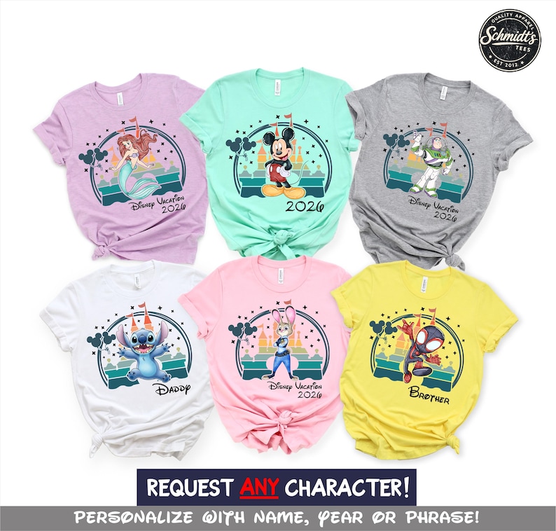 May include: A collection of colorful t-shirts featuring various Disney characters. Each shirt displays a character graphic with the text "Disney Vacation 2026" or "Daddy" or "Brother". The shirts are in shades of pink, yellow, white, gray, and teal.