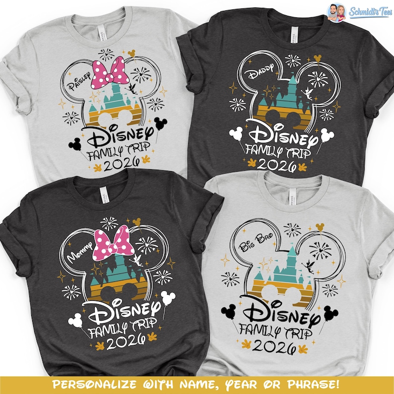 May include: Four t-shirts with a Disney Family Trip 2026 design. Each shirt features a Mickey Mouse head outline with a castle, fireworks, and text. The shirts are in gray, dark gray, and white, with text like "Paisley", "Daddy", "Mommy", and "Big Bro".