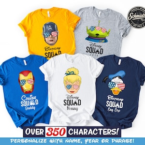 May include: Five colorful t-shirts with Disney character graphics wearing American flag sunglasses. The shirts include Captain America, an alien, Tinkerbell, Iron Man, and Donald Duck. Text on the shirts reads "Birthday Squad", "Cruise Squad Daddy", and "Disney Squad".