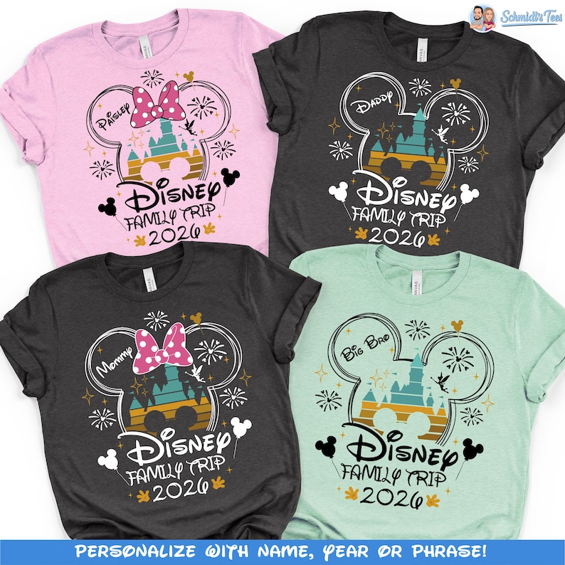 May include: Four short-sleeved t-shirts in pink, charcoal, and mint green. Each shirt features a Mickey Mouse head design with a castle, fireworks, and the text "Disney Family Trip 2026." The shirts are personalized with names like "Paisley," "Daddy," "Mommy," and "Big Bro."