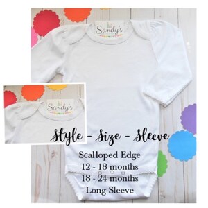 May include: White long-sleeve baby bodysuit with a scalloped edge collar. The bodysuit has a "Sandy's" label on the front. The text "Style - Size - Sleeve" is written below the bodysuit. The text "Scalloped Edge" is written above the text "12-18 months". The text "18-24 months" is written below the text "12-18 months". The text "Long Sleeve" is written below the text "18-24 months".