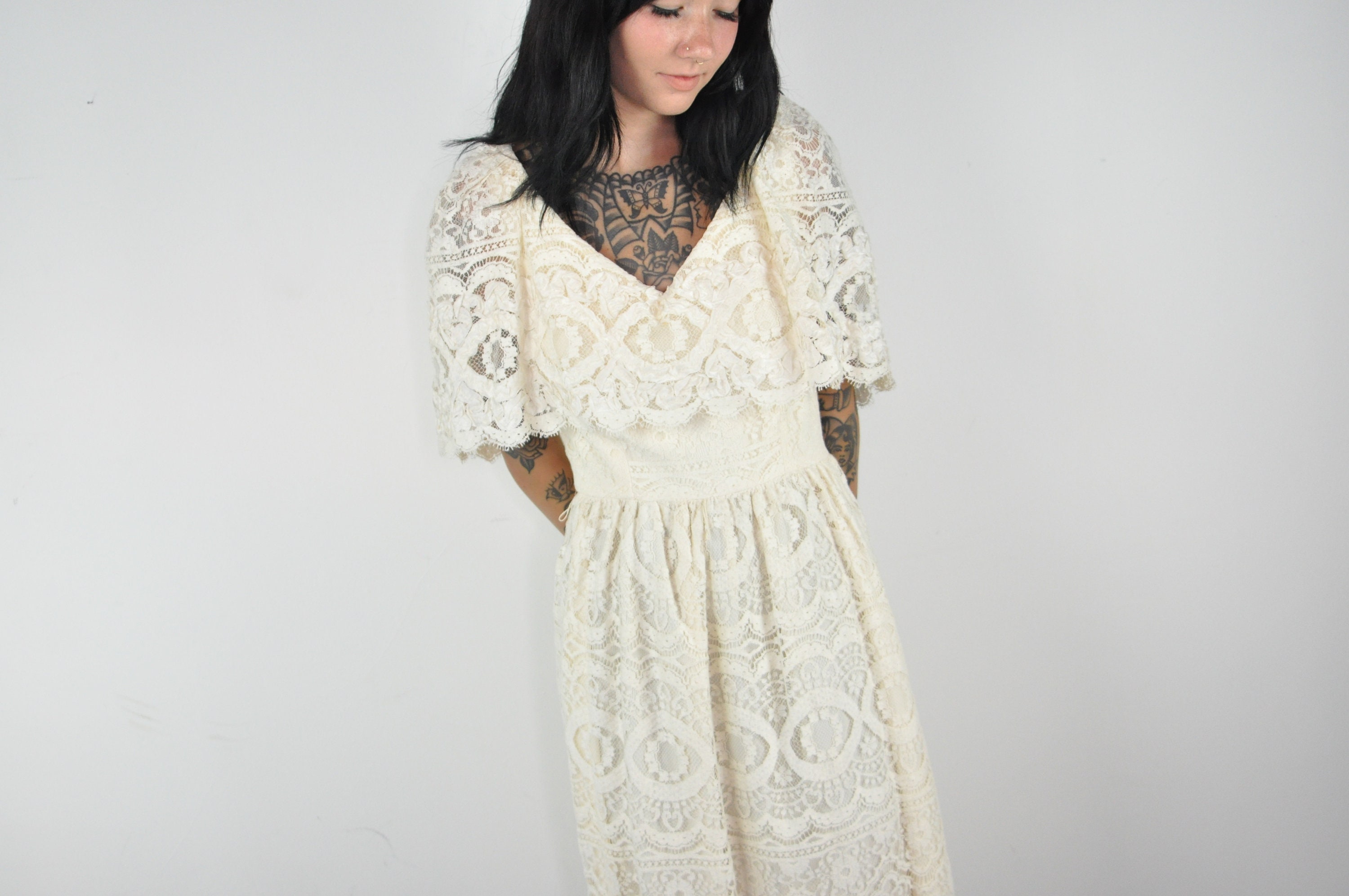 Black lace on the sides of a cream color dress | Beige lace dresses, Lace  dress, Beautiful dresses