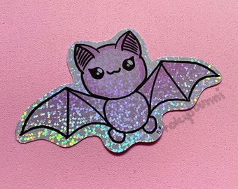 Pegatina de vinilo holográfica con diseño de murciélago morado kawaii y brillos pastel gótico
