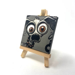 Mad J Gifts Enigmatic Paws mini canvas print. Gray background with big eyed dog.