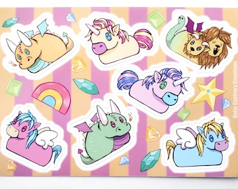 May include: A sheet of colorful stickers featuring various mythical creatures, including unicorns, dragons, and a griffin. The stickers are on a pink and yellow striped background with scattered gems and a rainbow.