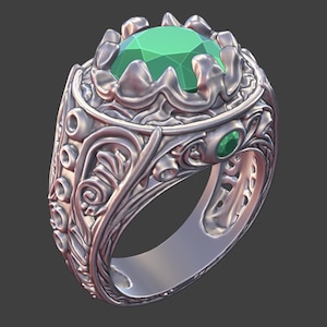 May include: A silver ring with an ornate design, featuring a large, faceted green gemstone at the center. The ring has detailed scrollwork and smaller green gems on the band, showcasing a classic jewelry style.
