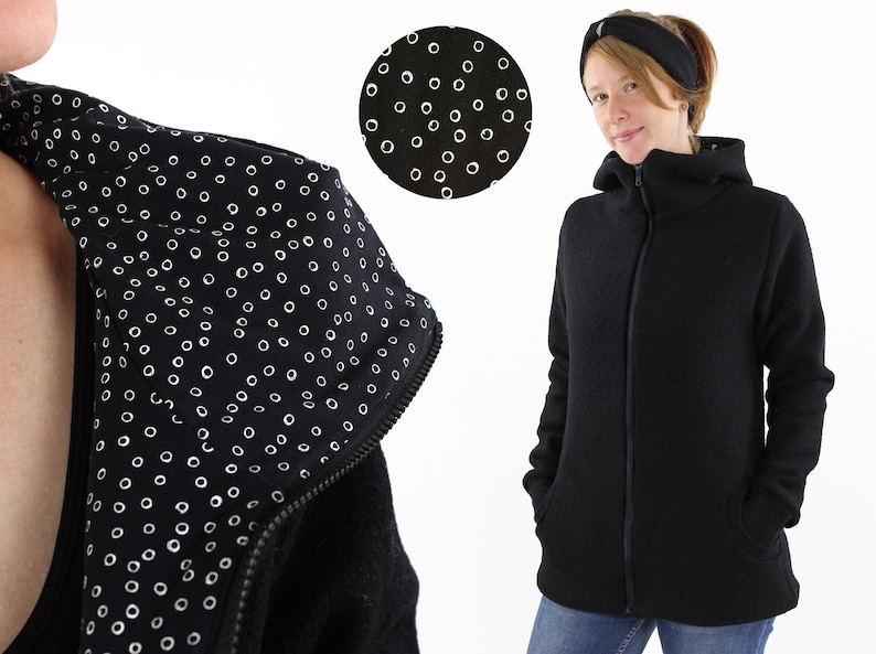 May include: Black hooded jacket with a zipper closure and a white polka dot pattern on the inside of the hood.