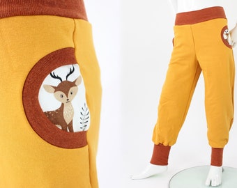 Yellow children's play pants with forest animals