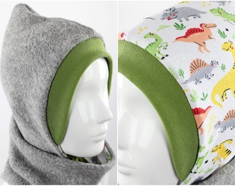 May include: Two hooded hats with green trim. One hat is grey fleece and the other is white with a dinosaur print.